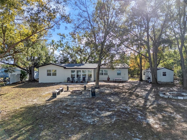 back of property with a storage unit