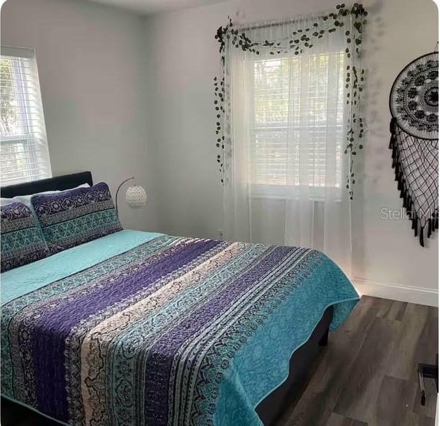 bedroom with hardwood / wood-style floors