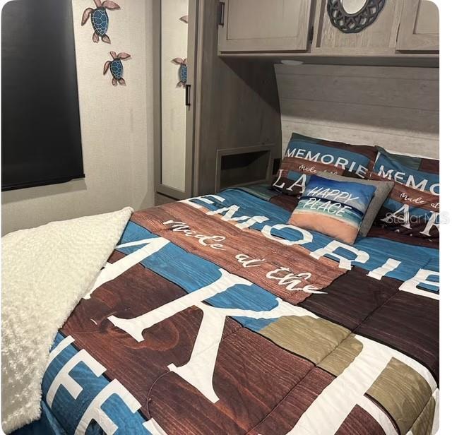 bedroom featuring wood walls