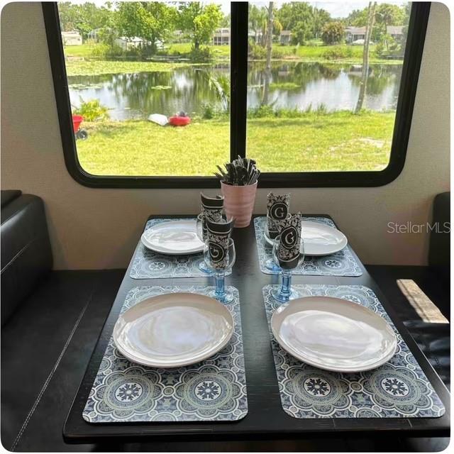 dining room featuring a water view