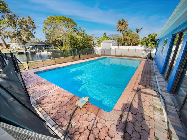 view of swimming pool with a water view