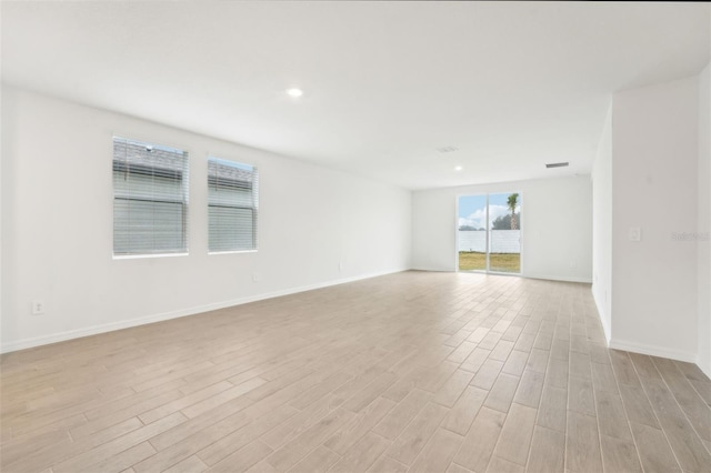 empty room with light hardwood / wood-style flooring