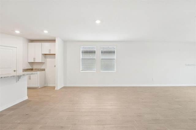 unfurnished living room with light hardwood / wood-style flooring