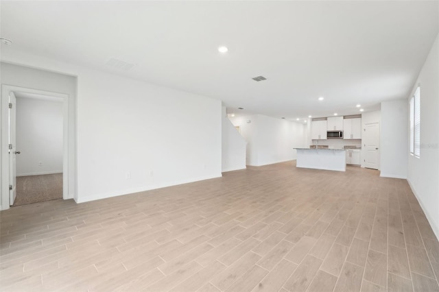 unfurnished living room with light wood-type flooring