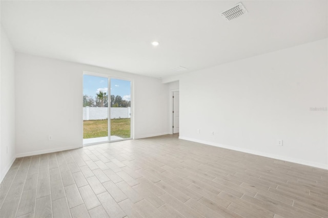 spare room featuring light hardwood / wood-style floors