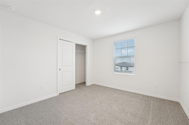 unfurnished bedroom with carpet floors and a closet