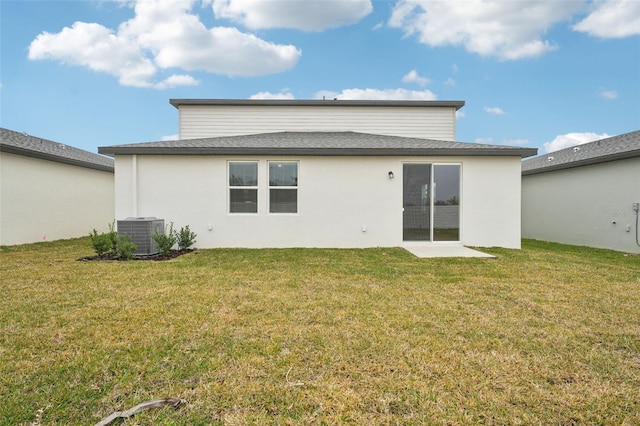 back of house featuring cooling unit and a yard