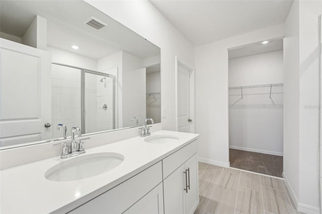 bathroom with walk in shower and vanity