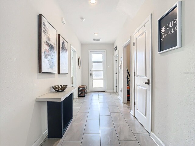 entryway with light tile patterned floors