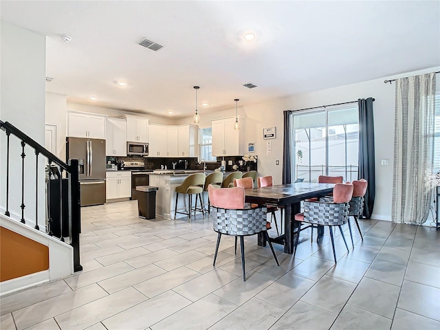 dining area featuring light tile patterned floors