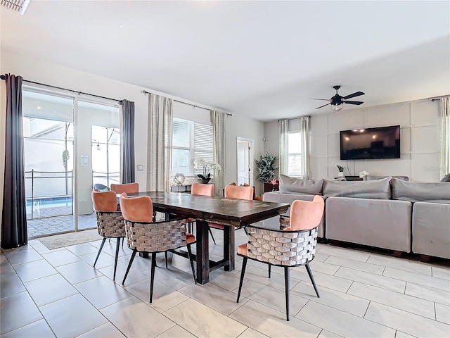 tiled dining space featuring ceiling fan