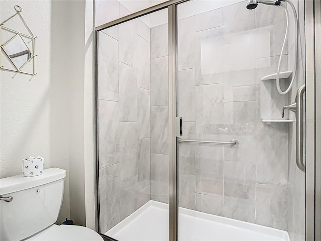 bathroom with toilet and an enclosed shower