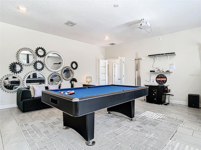 game room with billiards, light tile patterned flooring, and a textured ceiling