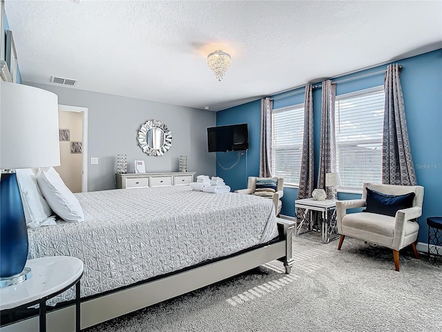 carpeted bedroom featuring a textured ceiling