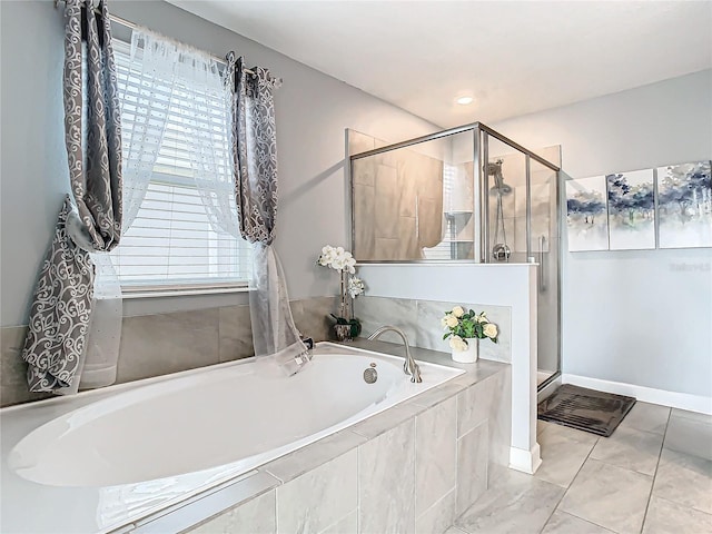 bathroom with independent shower and bath, tile patterned flooring, and a healthy amount of sunlight