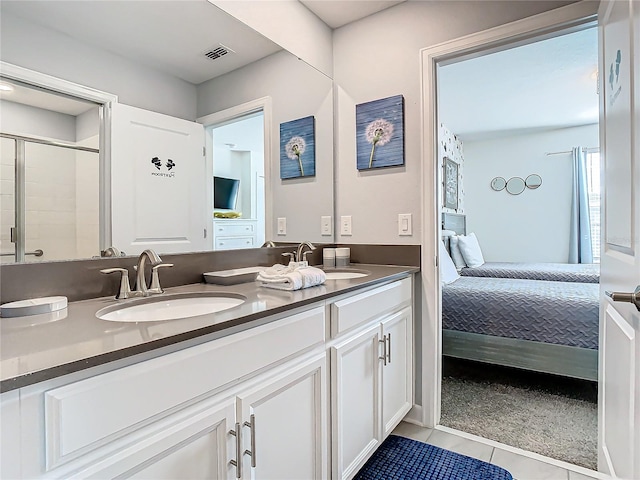 bathroom with vanity, tile patterned flooring, and walk in shower