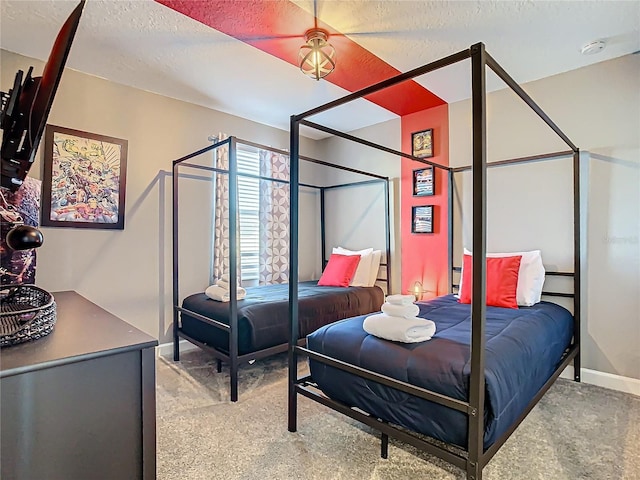 bedroom featuring a textured ceiling, ceiling fan, and light carpet