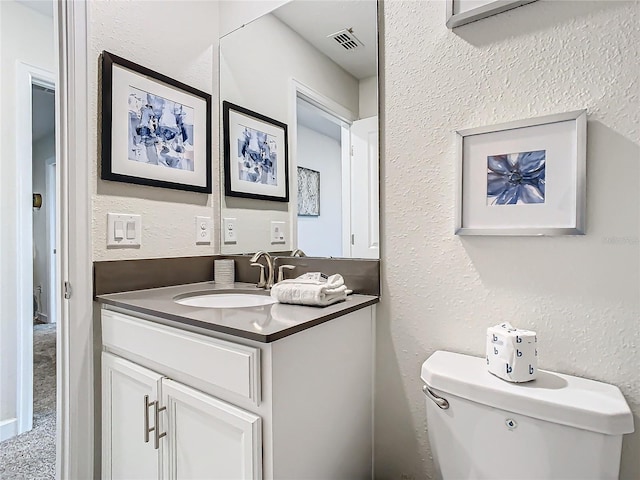 bathroom with toilet and vanity