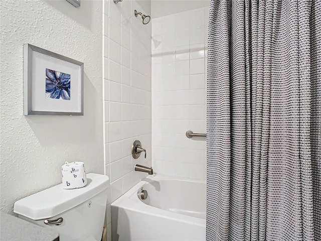 bathroom featuring toilet and shower / tub combo