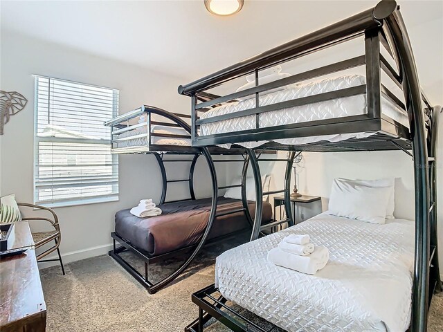 bedroom featuring carpet and multiple windows