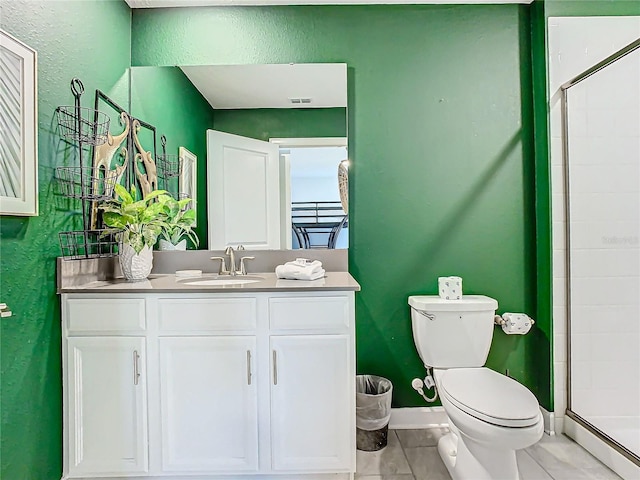 bathroom featuring toilet, tile patterned flooring, a shower with door, and vanity