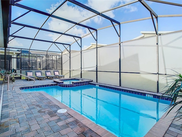 view of pool with an in ground hot tub, a lanai, and a patio area