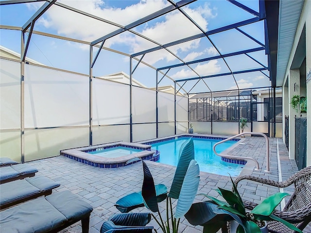 view of swimming pool with a patio, glass enclosure, and an in ground hot tub