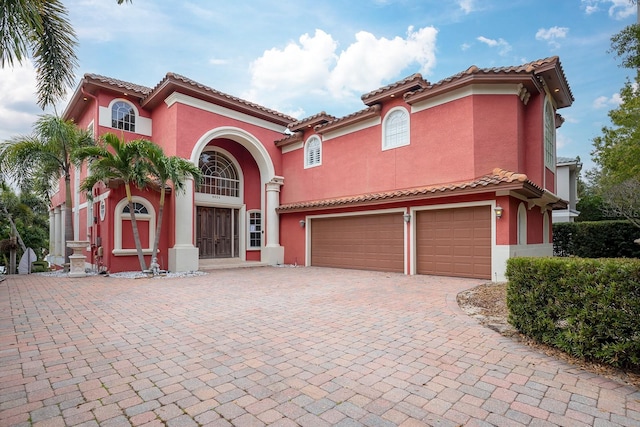 mediterranean / spanish house with a garage