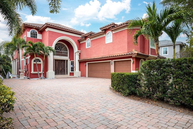 mediterranean / spanish house with a garage