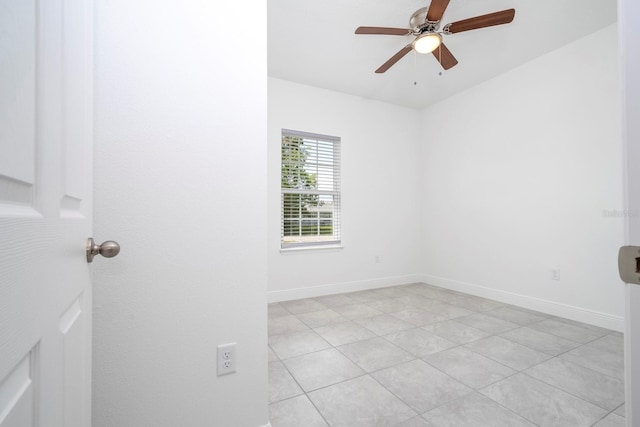 tiled empty room featuring ceiling fan