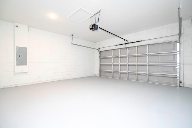 garage with a garage door opener and electric panel