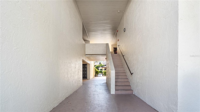 hall with concrete flooring