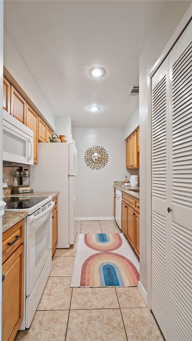 kitchen featuring white appliances and light tile patterned flooring