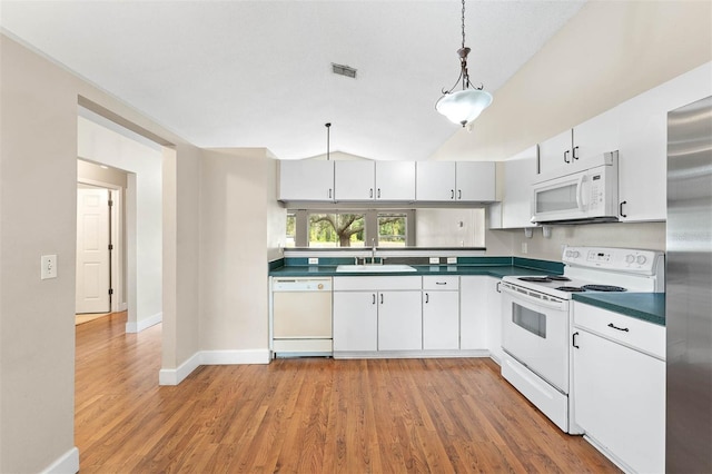 kitchen featuring pendant lighting, white cabinets, white appliances, and sink