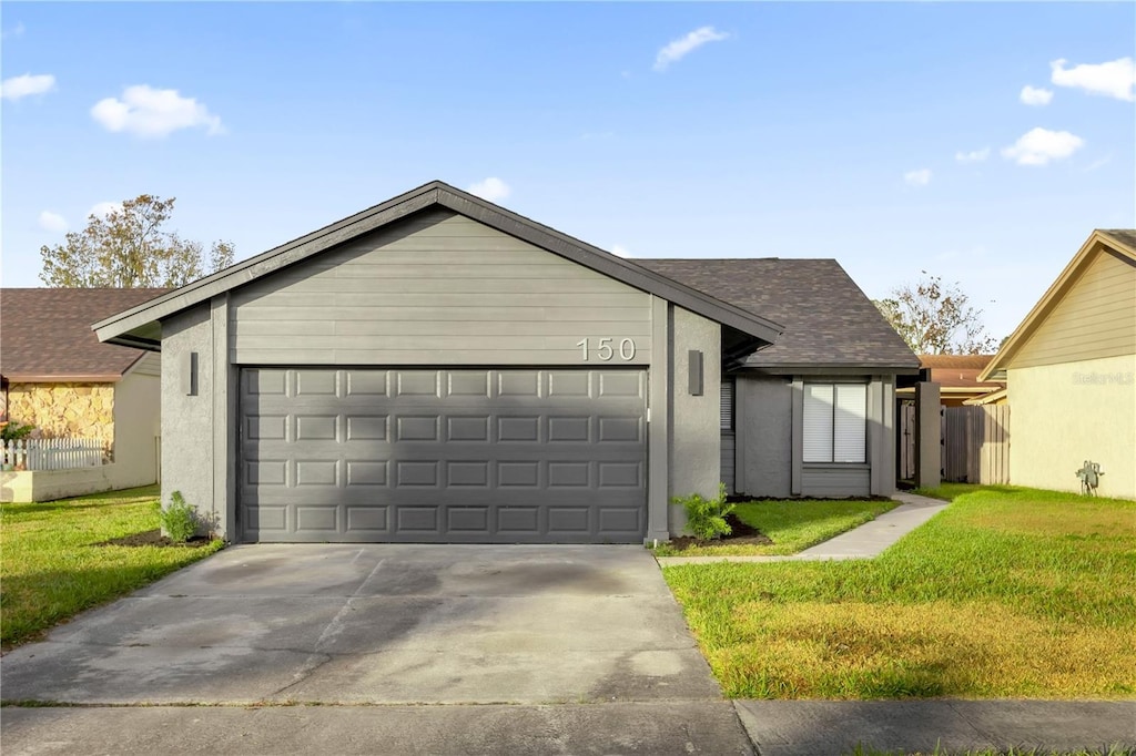 view of front of house featuring a garage and a front lawn