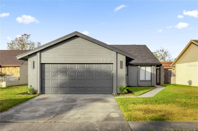 view of front of house featuring a garage and a front lawn