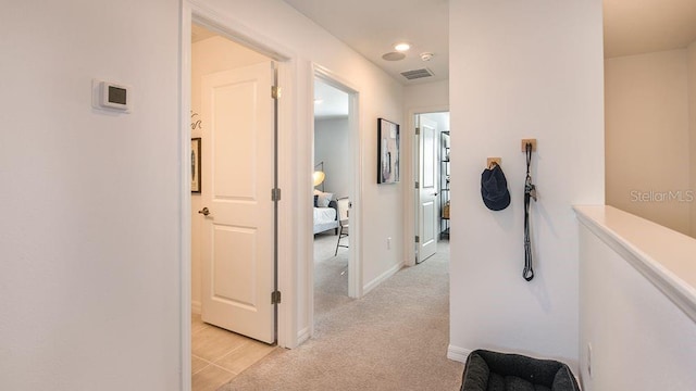 corridor with light colored carpet