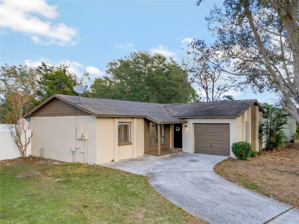 ranch-style home featuring a front lawn and a garage