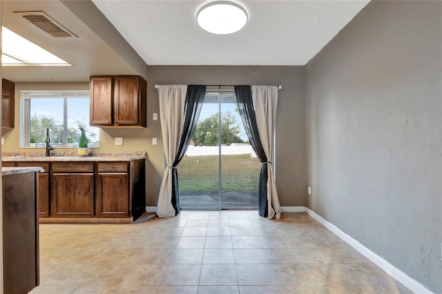 kitchen featuring light tile patterned floors and sink