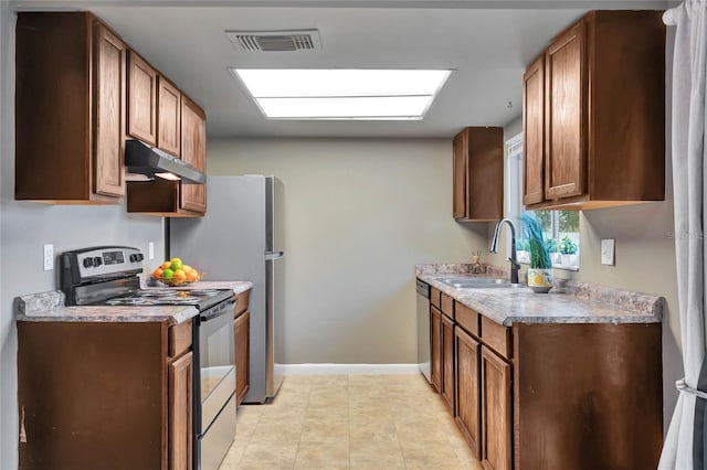 kitchen featuring sink, light tile patterned flooring, and stainless steel appliances