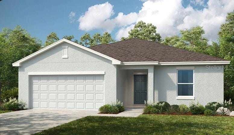 view of front of house with a front lawn and a garage