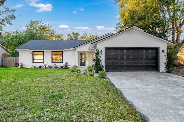 ranch-style house featuring a garage and a front lawn