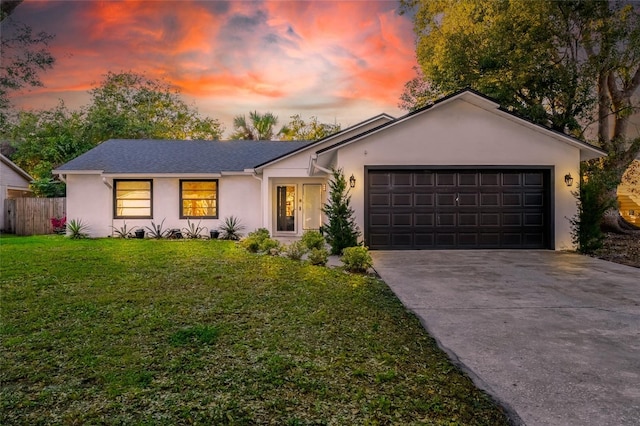 ranch-style home with a lawn and a garage