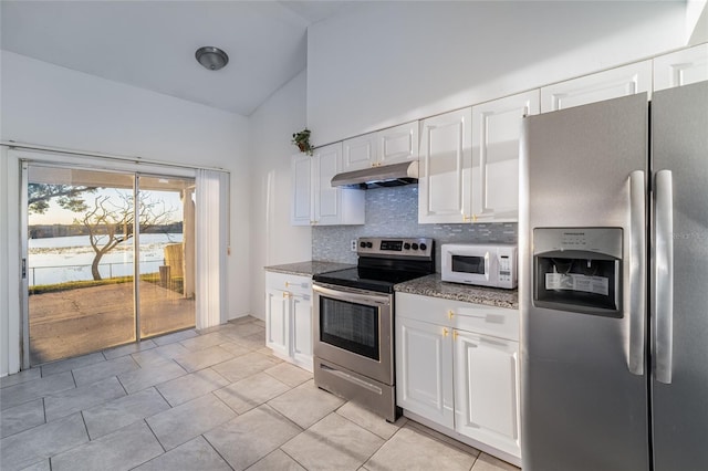 kitchen with white cabinets, backsplash, dark stone countertops, a water view, and appliances with stainless steel finishes