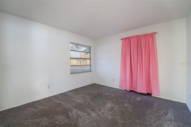 carpeted spare room with a textured ceiling