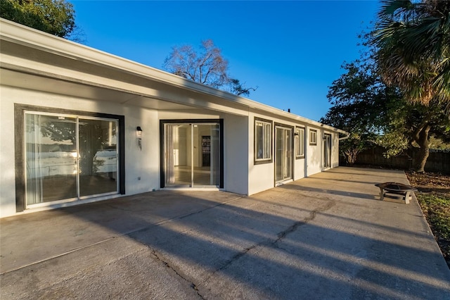 back of house featuring a patio and an outdoor fire pit