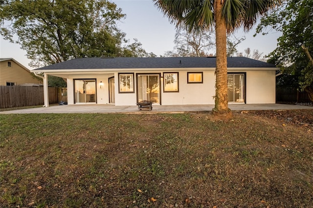 view of front of home with a patio and a front yard