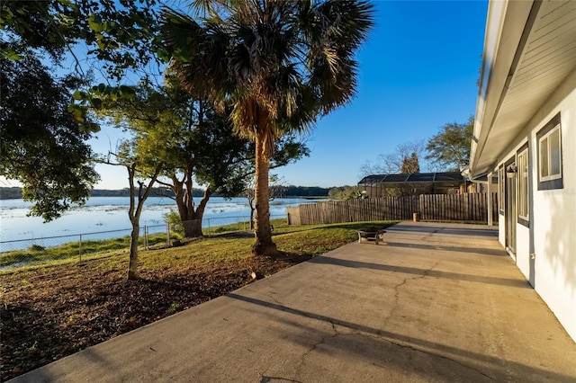 view of yard featuring a water view and a patio area