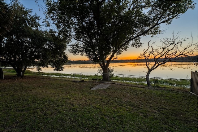 yard at dusk with a water view