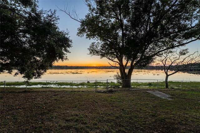 yard at dusk with a water view